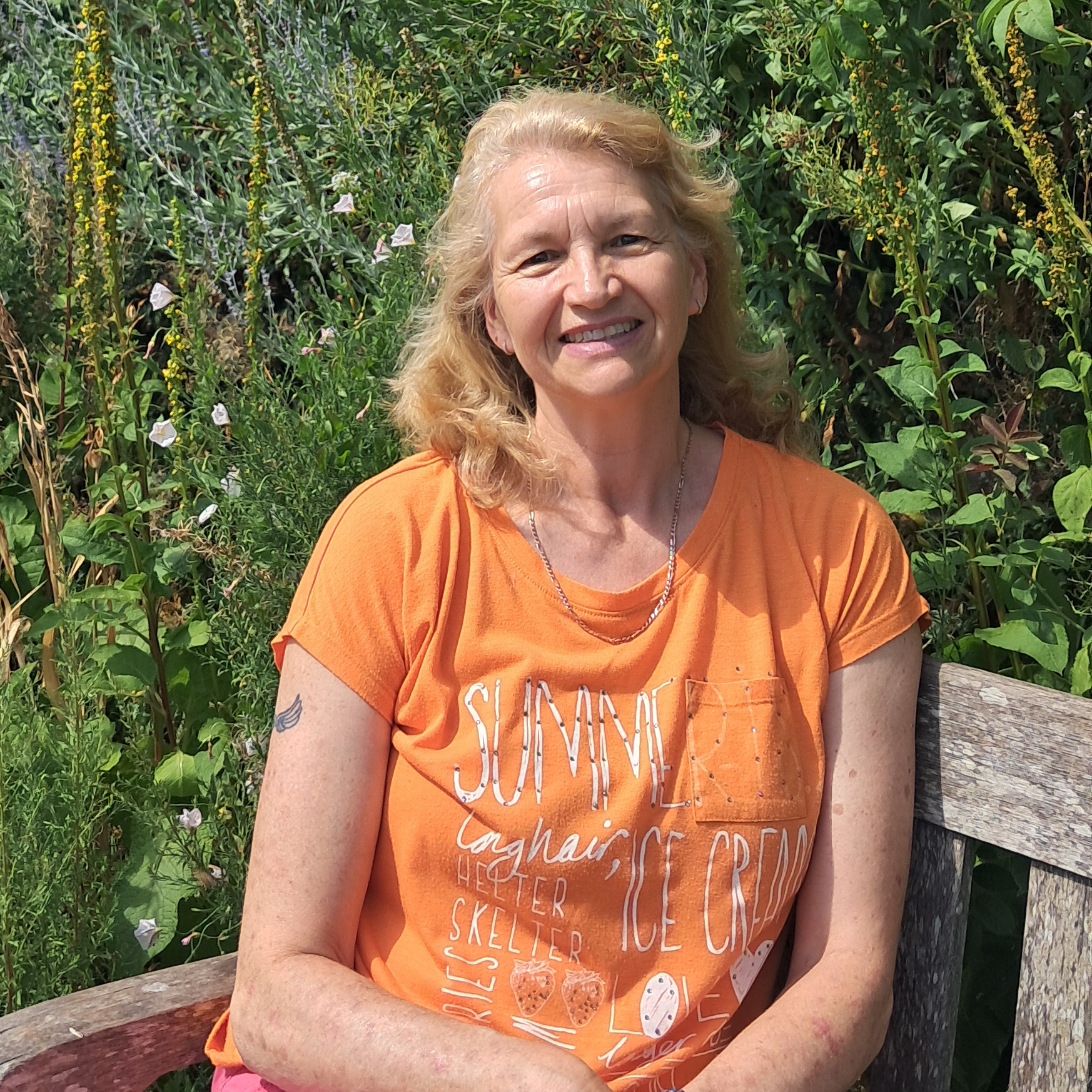 Andrea smiling outdoors in Somerset